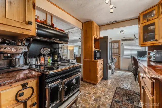 A charming vintage stove adds timeless character and a touch of nostalgia to this thoughtfully designed kitchen.
