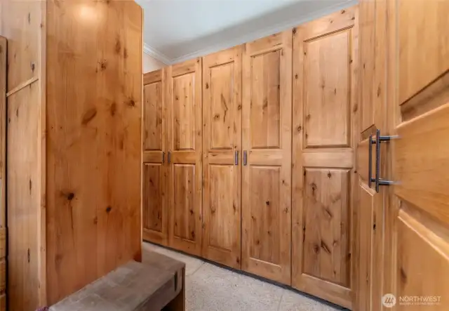 Open walk-in closet space with custom cabinetry.