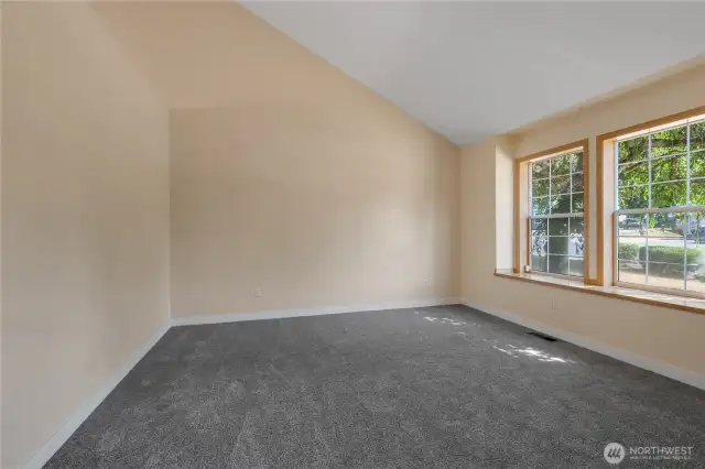 Formal living room with vaulted ceiling