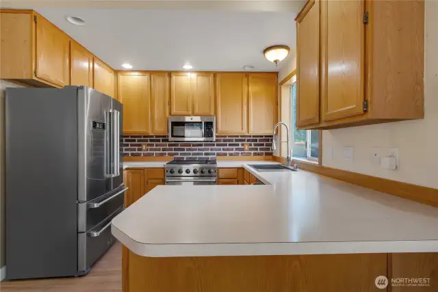 Kitchen is spacious and offers great cabinet space and gas stove.  All appliances are upgraded and newer.