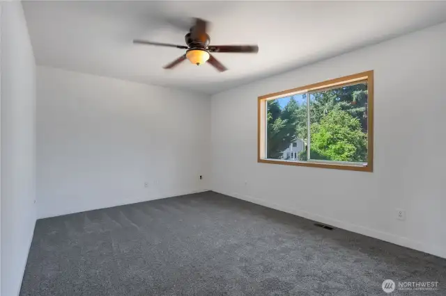 Primary bedroom with ceiling fan