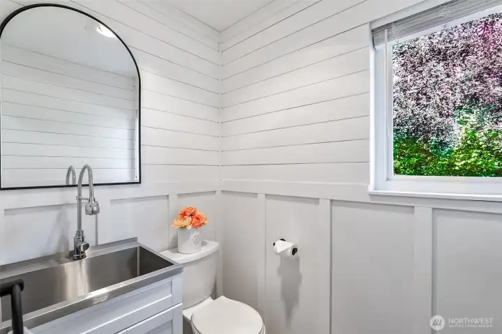 Downstairs half bath with utility sink.
