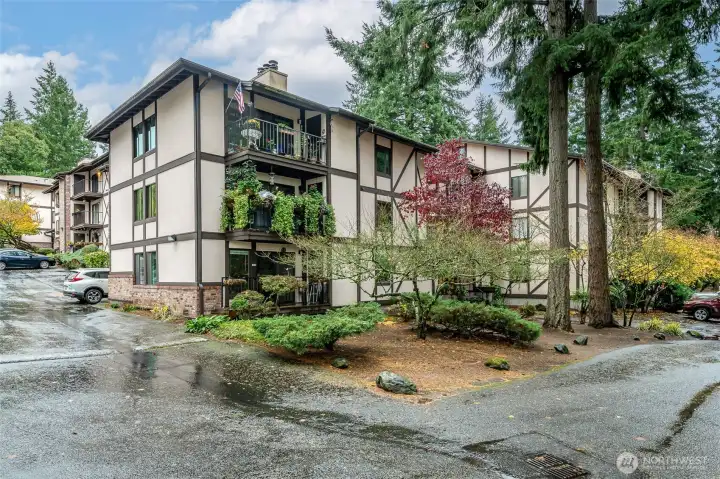 Northwest corner of the building that the unit is in and also situated on the Northwest section of the condominium complex. The unit is just left around the corner. The entrance to the building is near the 2 tall fir trees.