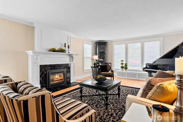 The formal living room is centered around a marble slab gas fireplace.