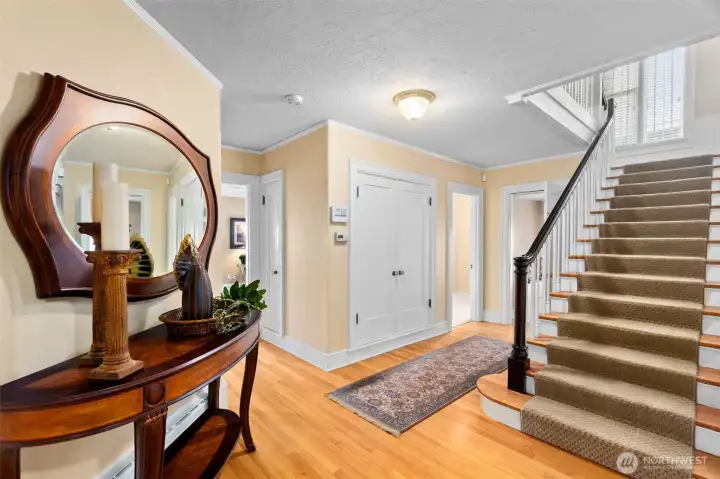 A transitional space that connects access to all areas of the home. The large closet is much bigger than you'd expect, plus an additional coat closet outside the casual living room. A view of the 1/2 bathroom and access to the lower level.