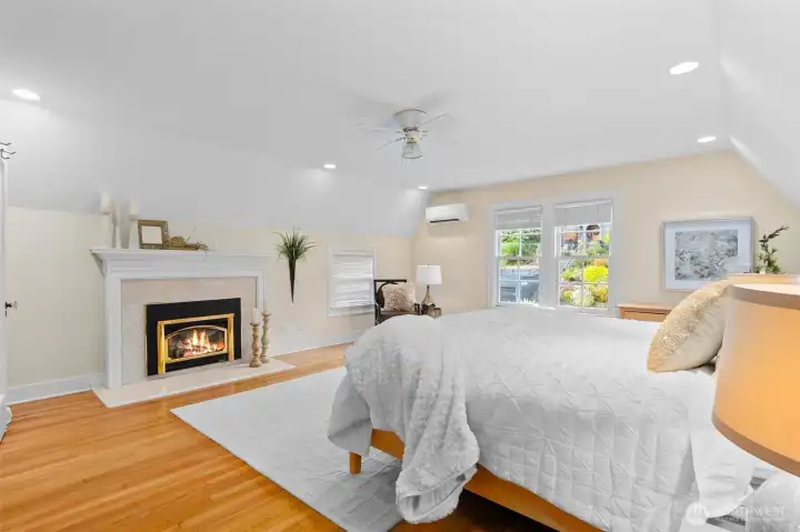 A refined primary suite featuring a spa-inspired bath, oversized walk-in closet, gas fireplace and a brand new Daikin mini-split unit.