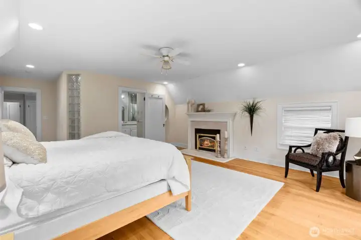 The timeless design continues from the main level to the primary suite with original oak hardwood floors, granite fireplace, and marble shower and counters in the en-suite bath.