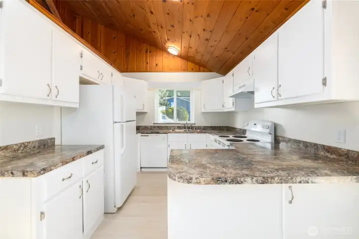 Kitchen is freshly painted and has new countertops, vaulted wood ceiling.