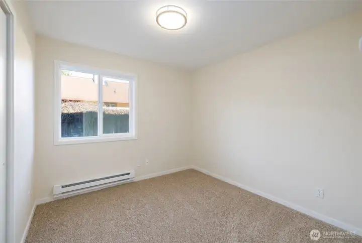 First bedroom off bonus room has zonal baseboard heat, new carpet and paint.