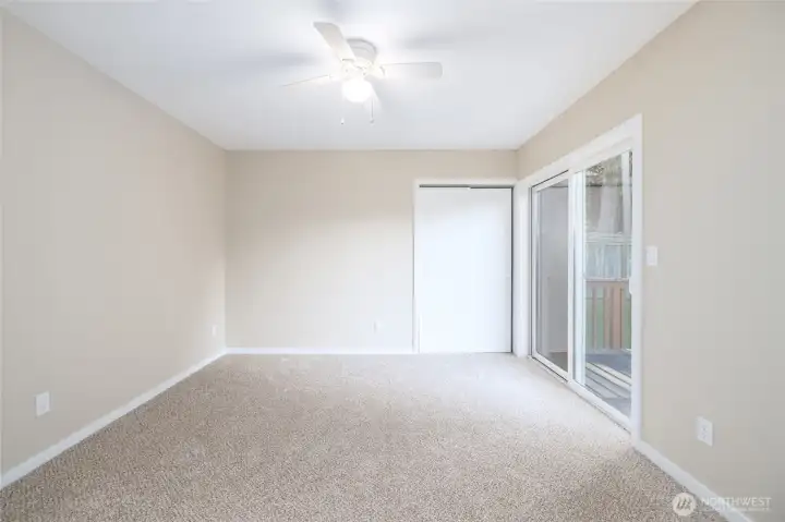 Another view of master bedroom with slider to deck and backyard.