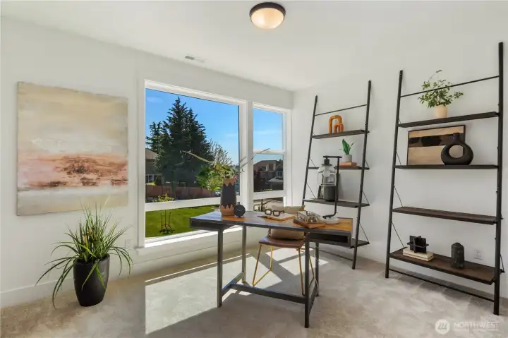 Den / Main Level Bedroom: Flexible den or main level bedroom with large windows and soft carpet, perfect as a private office, playroom, or guest retreat.  Staged photos are of the model home of the same floorplan within the Foxmoore community and are for visualization purposes only. Colors, finishes, and layout can and will vary.