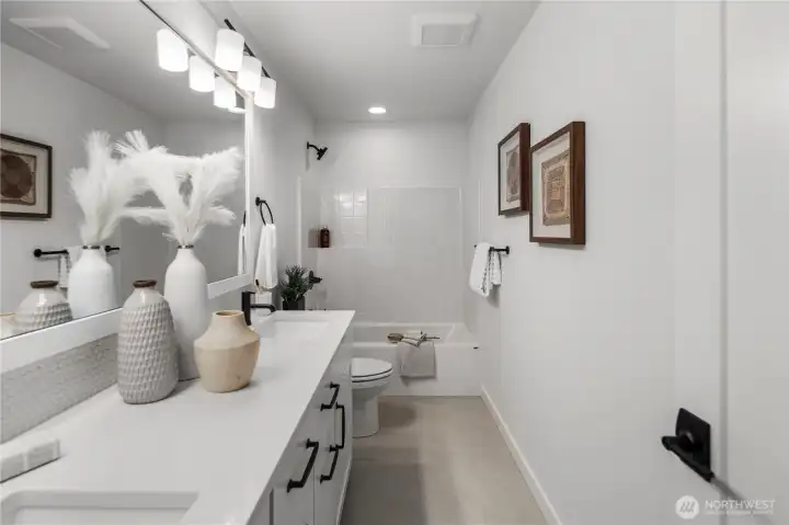 Full Bathroom: Upstairs bathroom with dual-sink vanity, modern fixtures, and a full tub/shower combo. Clean lines and bright finishes create a comfortable and stylish space.  Staged photos are of the model home of the same floorplan within the Foxmoore community and are for visualization purposes only. Colors, finishes, and layout can and will vary.