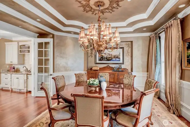 Dining room is the perfect entertaining spot. Spectacular crown moulding adorns this room. Butlers pantry  to the left