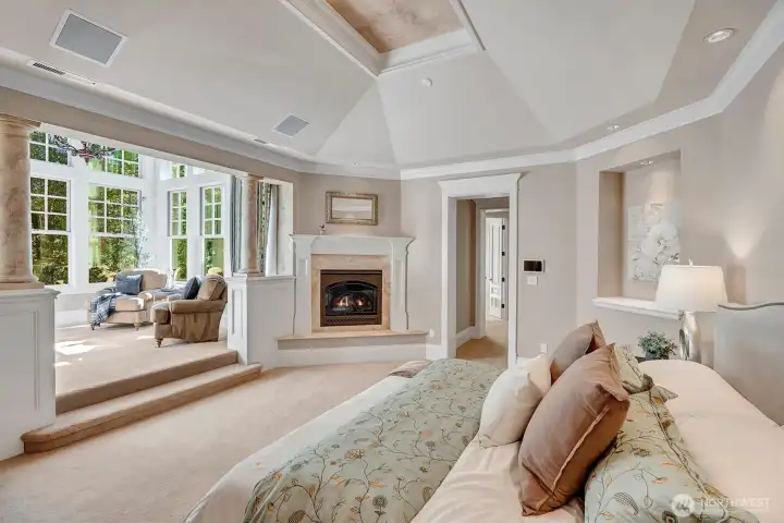 Lavish primary suite with fireplace and sitting room also with a fireplace