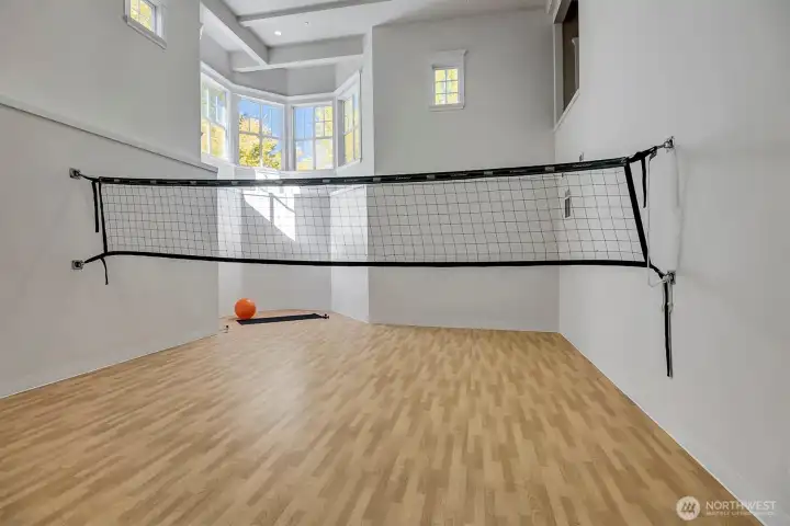 Down a flight of stairs you will find the gym. While this is set up for volley ball, it could be basket ball or any sport you would desire. Note how tall the ceilings are