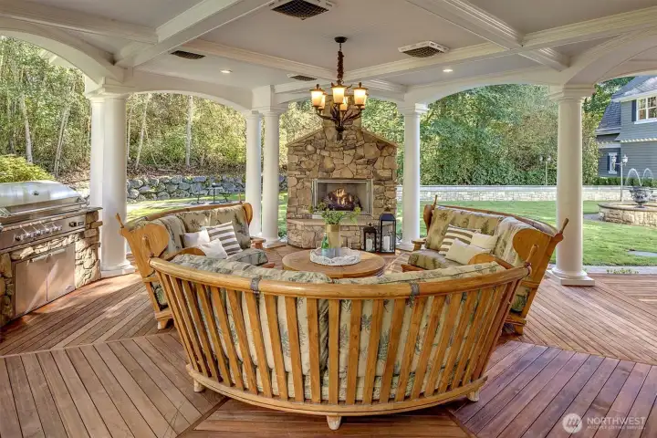 Covered deck area features gas fireplace and large grill. Built in heaters keep this covered area nice and toasty