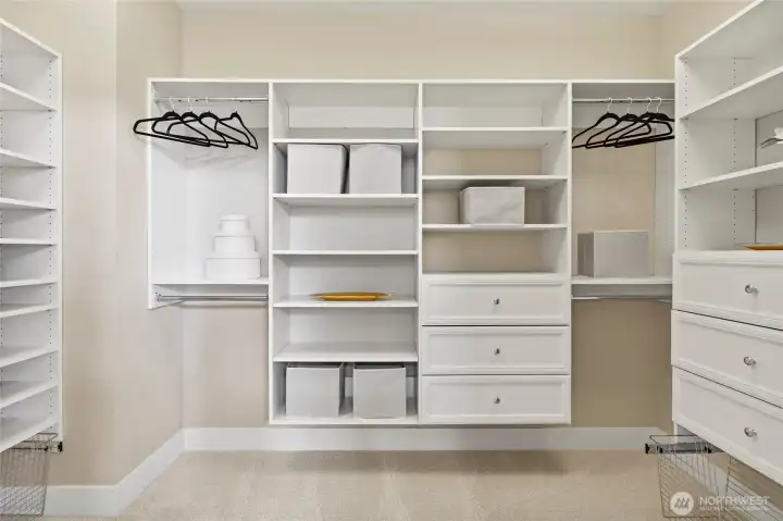 Spacious walk-in closet with custom built-ins.