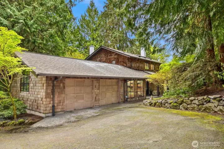 A spacious two-car garage is complemented by a covered front porch, where skylights above invite soft, natural light and create a warm, welcoming arrival.