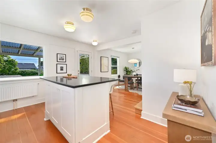 Granite island eating space in open kitchen with outlook to backyard deck. Granite island eating space in open kitchen with outlook to backyard deck.