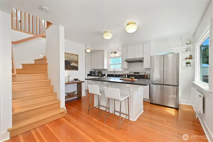 Access to upper level off kitchen via custom staircase. Access to upper level off kitchen via custom staircase.