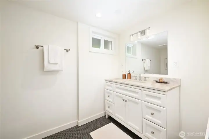 Lower level 3/4 bath has tiled floor. Lower level 3/4 bath has tiled floor.