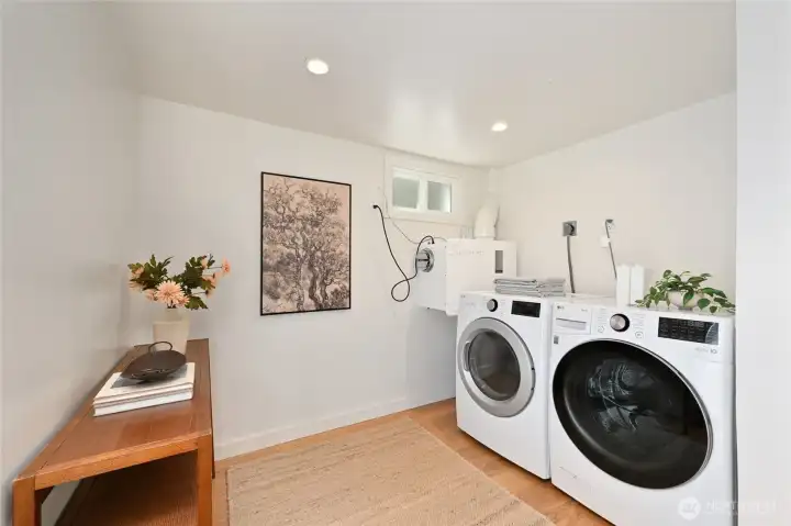 Large W/D area downstairs with the vacuum suction chute delivers laundry from primary bathroom. Large W/D area downstairs with the vacuum suction chute delivers laundry from primary bathroom.