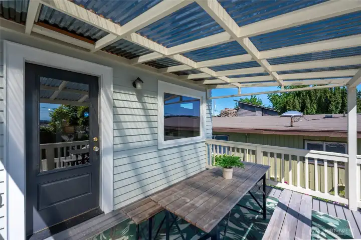 Covered deck area off the kitchen offers serene outlook to backyard. Covered deck area off the kitchen offers serene outlook to backyard.