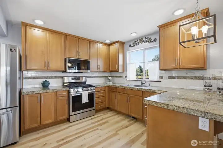 The bright and spacious kitchen anchors the home The bright and spacious kitchen anchors the home