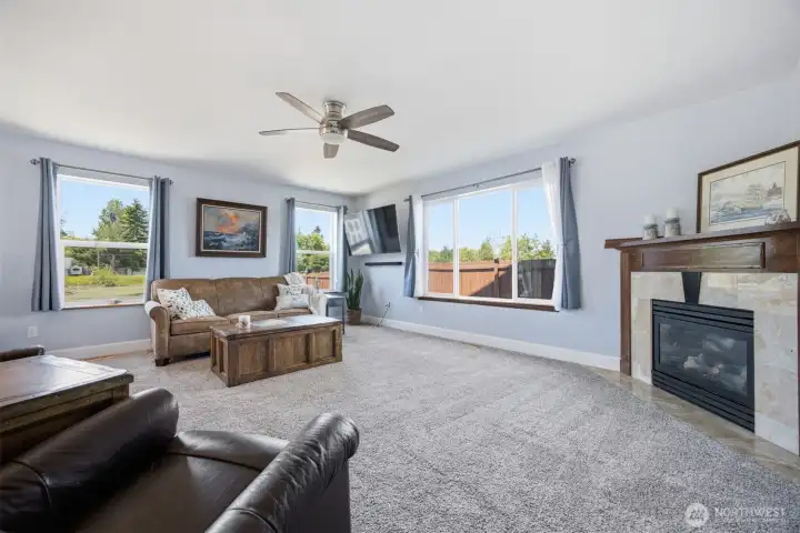 A large family room with gas fireplace and views of the pond A large family room with gas fireplace and views of the pond