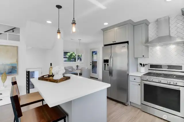 Kitchen with designer cabinets, slab countertops and quality stainless appliances.