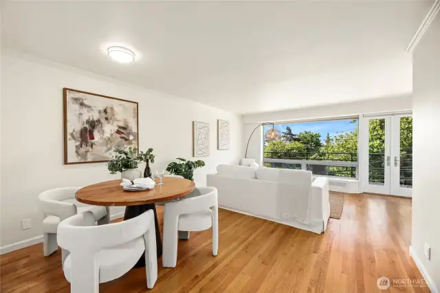 Drenched in natural Light the Living Room  and Dining Room  features real wood floors