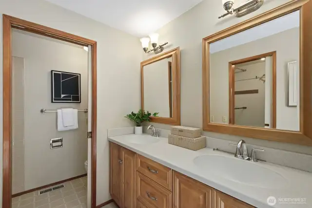 Your primary bathroom has double sinks with new faucets.