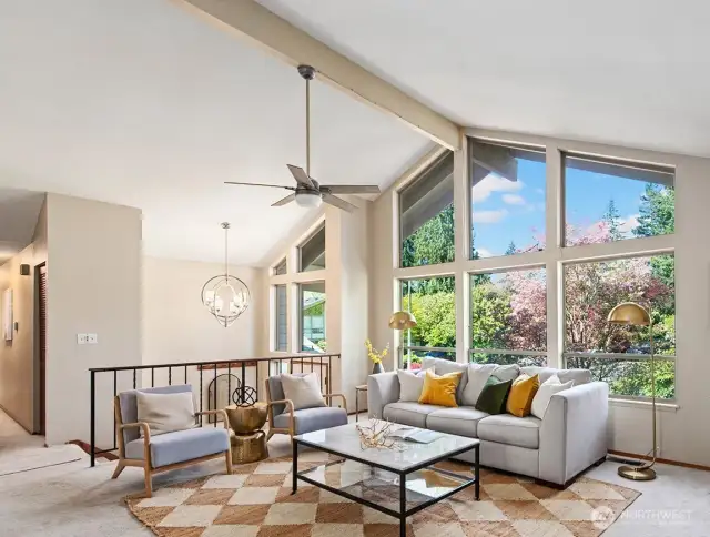 Soaring ceilings and massive windows bring in so much natural light! Plus, you're protected by lush plantings and trees so it feels incredibly private.