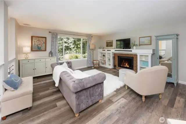 Newer LVP floors throughout. Warm wood-burning fireplace.