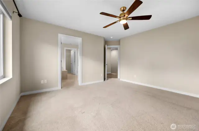 Primary bedroom looking at bathroom entrance and door to hallway!