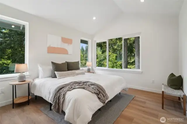 Photos of staged unit, 20313A. Primary bedroom with vaulted ceilings