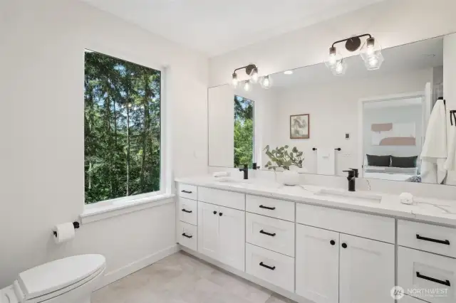 Photos of staged unit, 20313A. Primary bath with dual sinks and extensive cabinets
