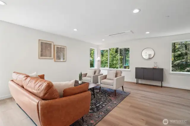 Photos of staged unit, 20313A. Floor plans are identical. Large windows overlooking treed open space