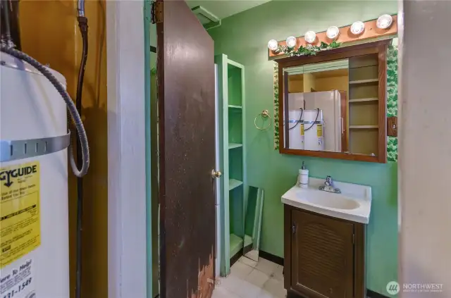 Main-level bathroom with built-in shelving and vintage charm—ready for a refresh to make it your own