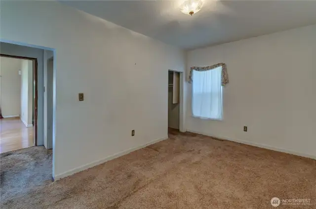 Charming upstairs bedroom with cozy sloped ceilings and soft natural light—ready for a restful retreat or creative refresh