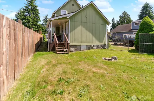 Fenced backyard with gated access, a covered back porch, and plenty of space to play, garden, or expand—imagine the possibilities!