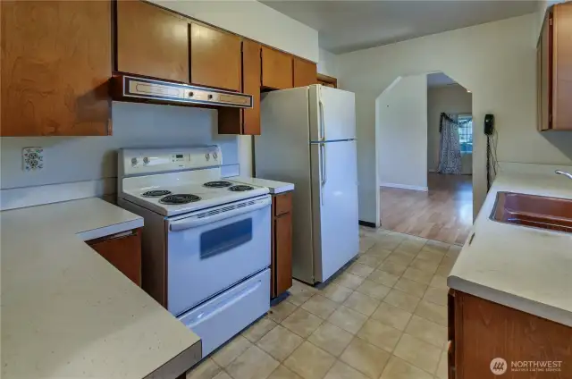 Functional and full of potential—this kitchen offers plenty of prep space, classic cabinetry, and easy flow into the main living area.