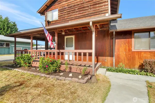 Classic front porch with space and concrete walkways.