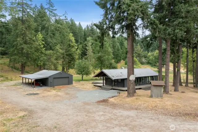 Your self-sufficient retreat in the woods—modern cabin, detached garage with 220 power, and plenty of space to grow.
