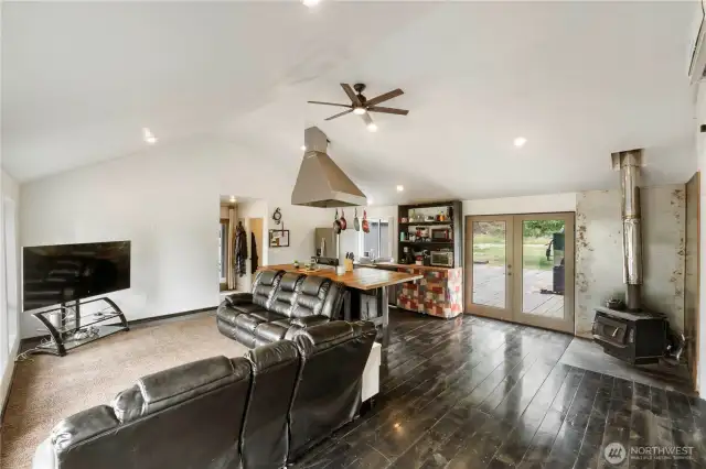 This cozy wood-burning stove adds a rustic charm and efficient warmth to the open living space, perfectly complementing the home's inviting atmosphere.