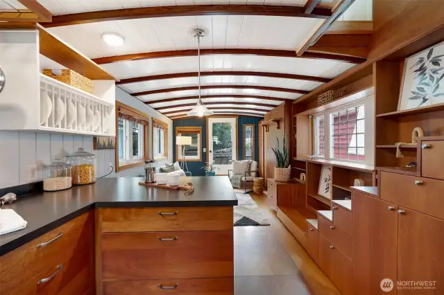 Rich wood custom cabinetry with smart storage details for living in 474 sq ft.