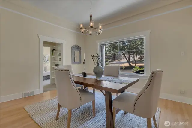 True to 1922 era, textured plaster walls & significant crown molding. Looking onto hallway bookshelf and main floor bedroom.