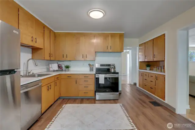 Farm-style kitchen with room for everyone.  Oiled to-the-ceiling cabinetry, induction range, storage galore.