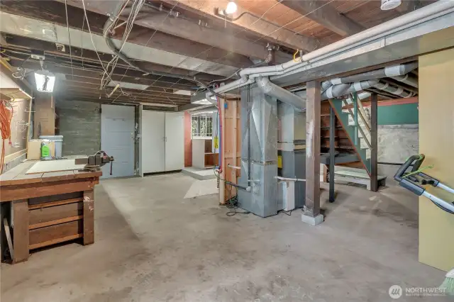 Over 1,000 sq. ft of dry, daylight basement with work bench and enclosed room to right.