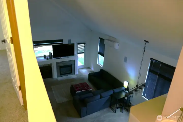 Living Room with vaulted ceiling from upstairs hallway